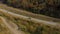 View from the height on the autumn landscape - river, railway, forest on a mountainside, cars on the road