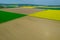 View from a height of the countryside and farm fields. Growing rapeseed and wheat.