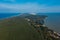 A view from a height of a narrow and long sandy saber-shaped strip of land separating the Curonian Lagoon from the