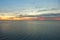 View from the height of the seascape with a beautiful dramatic sunset and a dark coastline.