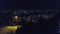 View from the height to the illuminated night city, multi-storey houses. Ukraine