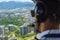 View from a helicopter cockpit flying over Rio de Janeiro. Cockpit with pilot and control board inside the cabin in a sunny day.