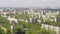 A view from helicopter flying over an urban area on sunny summer day. Flying past panel buildings of Soviet