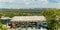 View of helipad on a rooftop of a building in a city park with panoramic metropolis view on the background