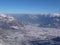 View from a high alpine mountain peak in Switzerland with a great view of the valleys and villages and mountains behind all covere