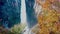 View of high Kegon Waterfall with the colorful foliage of autumn season and droplets of water floating in the air