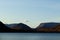 View of the high mountains and the wide lake in Kirovsk. Autumn picture of beautiful mountains, blue sky and blue lake. Kirovsk,
