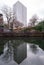 View of high rise block of flats in Birmingham City Centre, reflected in the water of the canal on a cold winter`s day.