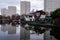 View of high rise blocks of flats in Birmingham City Centre, reflected in the water of the canal on a cold winter`s day.