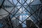 View of high-rise modern office buildings looking through steel mesh-like structure