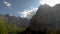 View of high rocky mountains with clouds in the sky. Timelapse.