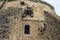 View of high wall with window and embrasure in ancient Olesko castle. Lviv region in Ukraine. Cloudy summer day