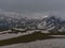 View of highest section of Grossglockner High Alpine Road from Edelweissspitze in Austria with snow-covered meadows and mountains.