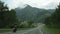 View of the highlands through the windshield during the car drive on a overcast spring morning. Picturesque country