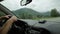 View of the highlands through the windshield. dashboard and steering wheel with driver`s hands, morning fog on the