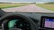 View of highway with moving cars through windshield of BMW iX3 M Sport.