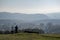 View from the hill on Sasova - part of town Banska Bystrica, Slovakia. Block of flats in valley. A couple with a doy enjoy