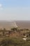 View from hill of Serengeti plain with dusty track