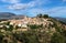 View of the hills of Polop de Marina with church and castell over green forest at the Costa Blanca, Spain