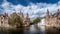 View of the historic buildings and the Belfort Tower from the Dijver canal in the medieval city of Brugge