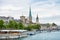 View of the historic buildings and bridge of Zurich at the bank of Limmat River and Zurich lake, with landmark of FraumÃ¼nster