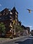 View of historic town hall of Oberwesel in city center with flags, flowers and big wine glass sculpture.