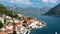 View of the historic town of Perast at famous Bay of Kotor on a beautiful sunny day with blue sky and clouds in summer, Montenegro