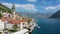 View of the historic town of Perast at famous Bay of Kotor on a beautiful sunny day with blue sky and clouds in summer, Montenegro