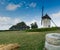 View of the historic windmill Moulin de Pierre and old millstones in Hauville in Normandy