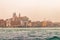 View of historical buildings surrounded by water in the morning mist in the city of Venice