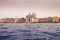 View of historical buildings surrounded by water in the morning mist in the city of Venice