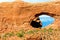 View on holes in red sandstone rock wall against blue sky - The windows, Arches national park, Utah