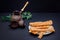 View of homemade sesame covered grissini, vintage style cups and coffee pot