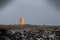 View of Hopsnes Lighthouse against the background of the cloudy sky. Iceland.