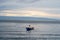 view of the horizon of lake toba in the morning with cloudy weather with a fisherman in the middle of the lake