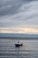 view of the horizon of lake toba in the morning with cloudy weather with a fisherman in the middle of the lake