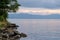 view of the horizon of lake toba in the morning with cloudy weather with a fisherman in the middle of the lake