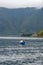 view of the horizon of lake toba in the morning with cloudy weather with a fisherman in the middle of the lake