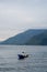 view of the horizon of lake toba in the morning with cloudy weather with a fisherman in the middle of the lake