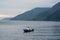 view of the horizon of lake toba in the morning with cloudy weather with a fisherman in the middle of the lake