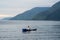 view of the horizon of lake toba in the morning with cloudy weather with a fisherman in the middle of the lake