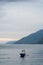 view of the horizon of lake toba in the morning with cloudy weather with a fisherman in the middle of the lake