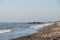 View of Horsey Gap beach, Norfolk, UK, selective focus, unidentifiable people on horizon