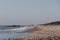 View of Horsey Gap beach, Norfolk, UK, selective focus, unidentifiable people on horizon