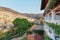 View of the hotel terraces, columns and roofs and the city on the slopes of the mountains