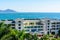 View from the hotel to clear turquoise sea, mountains, beach, jet skis, motor boats and parachutes on the coast of Dadonghai Bay