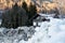 View of the house behind a huge snowdrift against the backdrop of the mountains in Europe