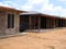 View of a house construction with wooden slats and cement.