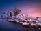 View at house in the Hamnoy village, Lofoten Islands, Norway. Landscape in winter time during blue hour. Mountains and water.