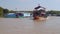 View of houses of floating village and boats with tourists